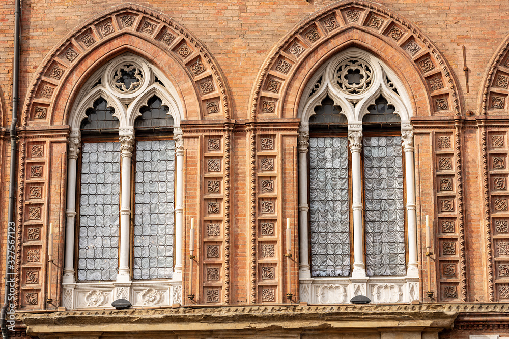 Closeup of two mullioned windows (bifore) of the Palazzo d'Accursio, Town hall in downtown of Bologna (XIII century), Piazza Maggiore, Emilia-Romagna, Italy, Europe