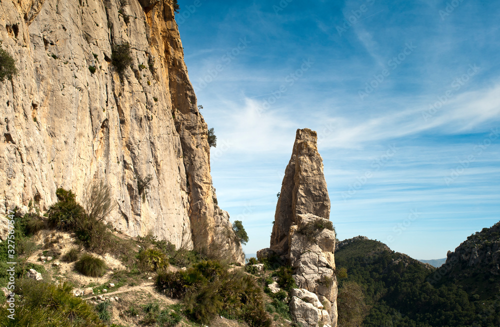 rock climbing mountain with beautiful landscape in the background with blue sky and soft clouds