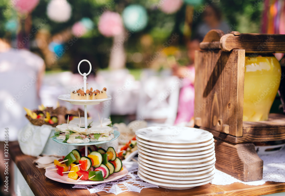 Fototapeta premium Food on table on kids birthday party outdoors in garden in summer.