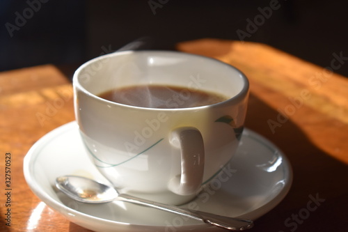 A cup of hot tea with milk on wooden table, Traditional english tea