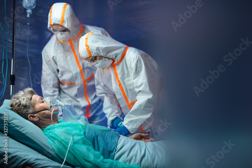 Infected patient in quarantine lying in bed in hospital, coronavirus concept. photo
