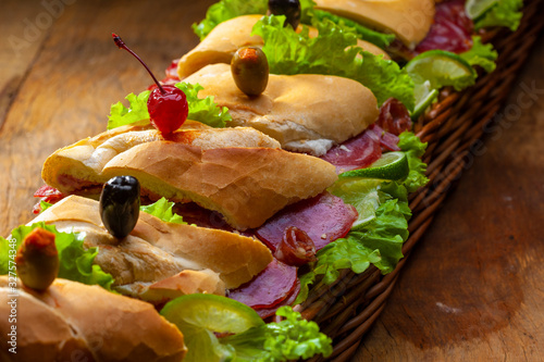 sanduiche de metro com recheio de frios e queijos photo
