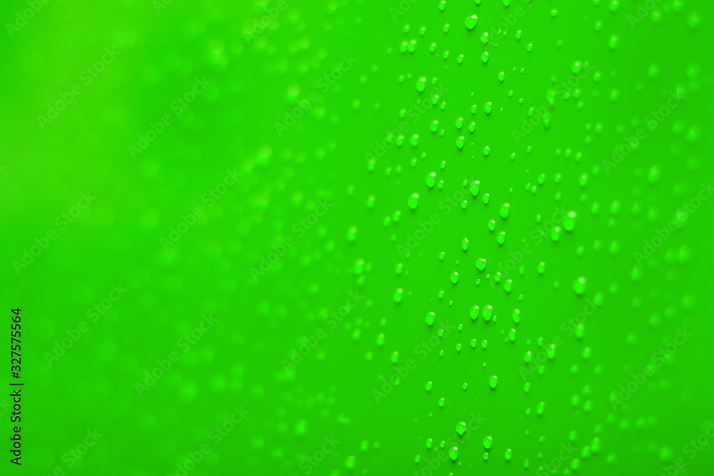 soft focus water drops on vivid green surface perspective blurred background space concept 