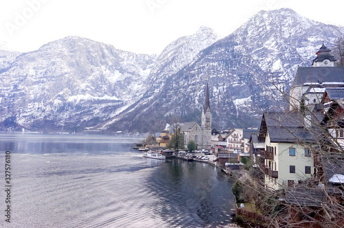 Hallstatt heritage village landmark for tourism sightseeing check point. Houses with tradition style old European architecture building on right side and clear lake on left. During cold winter season.