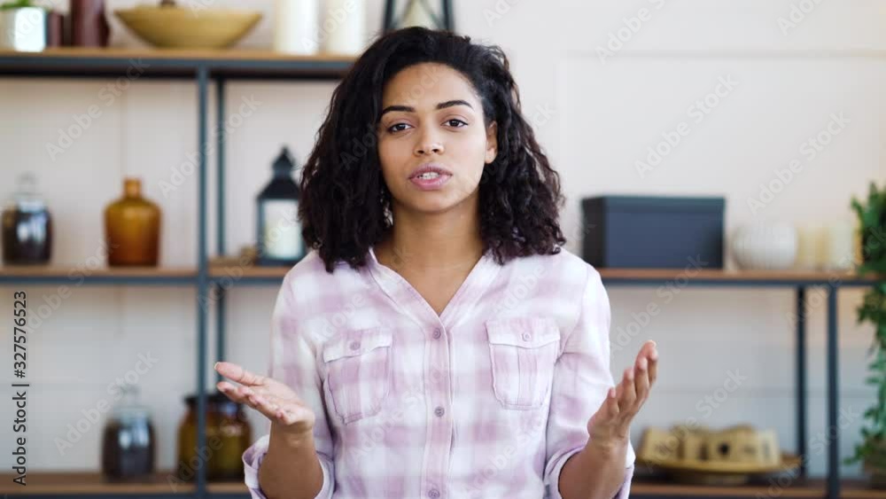 Emotional black girl talking and gesturing with hands at home Emotional black girl talking and gesturing with hands at home