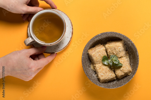 Sweet dessert with tea on a colored background
