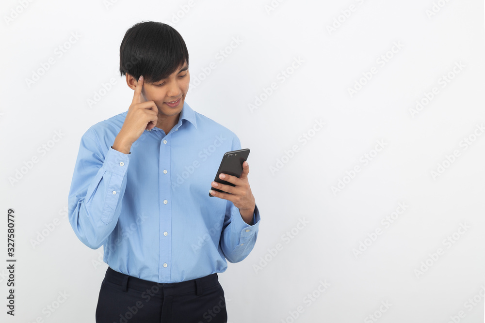 Young handsome asian business man playing smartphone with smiling isolated on white background. Young handsome asian business man playing smartphone with smiling isolated on white background.