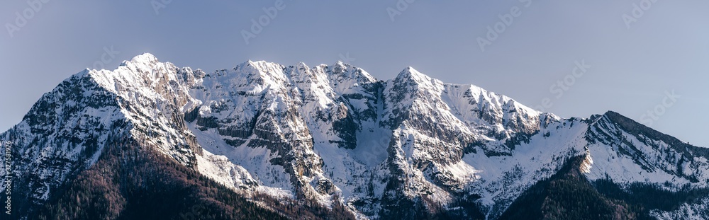 the snowy mountains of the Brembana valley, between the Italian alps, during a fantastic winter day, near the town of Branzi, Italy - February 2020.