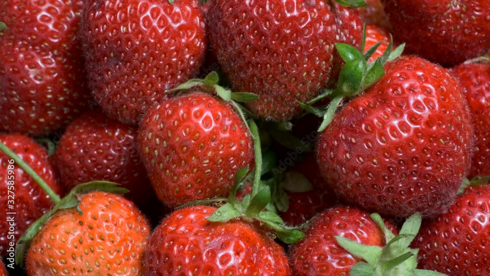 Sideways movement along juicy ripe strawberries. Close up, natural background. Camera moves sideway to the right side. 4K - 50fps Sideways movement along juicy ripe strawberries. Close up, natural background. Camera moves sideway to the right side. 4K - 50fps