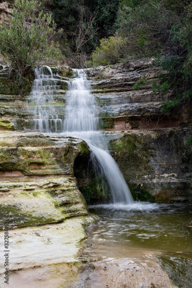 Fototapeta premium Beautiful waterfall splashing in the canyon creating a small lake