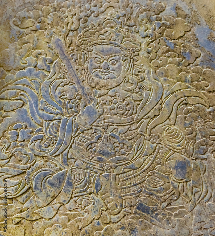 Thimphu/Bhutan - February 2016: Picture of Padmasambhava known as Guru Rinpoche carver on the stone in Chagri Cheri Dorjeden Monastery