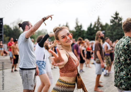 Beautiful young woman dancing at summer festival.