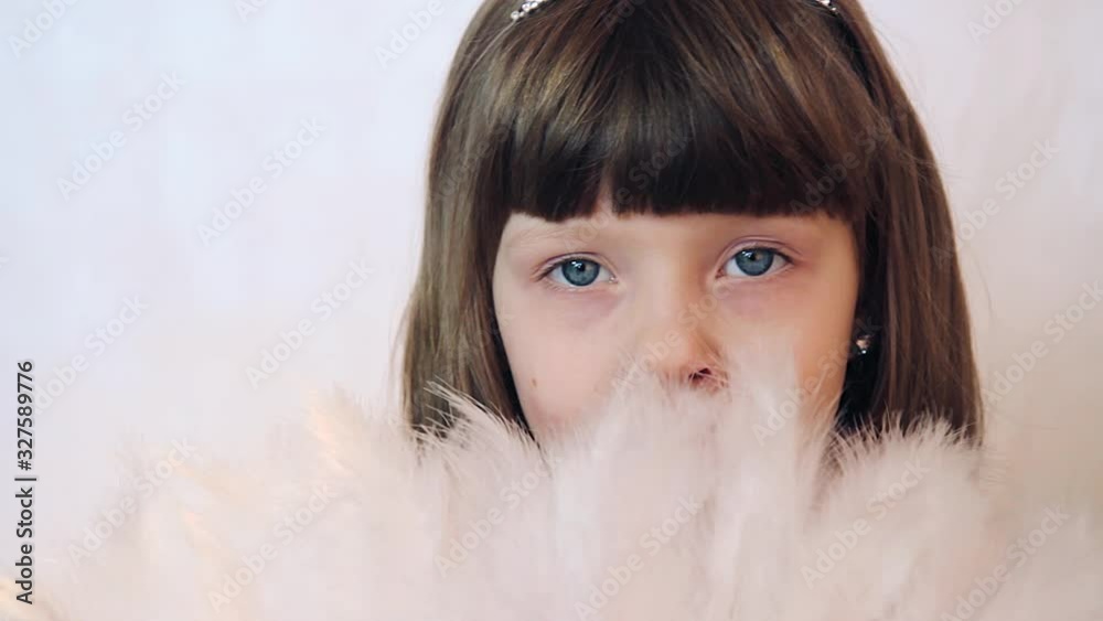 small girl princess with white hand feather fan
