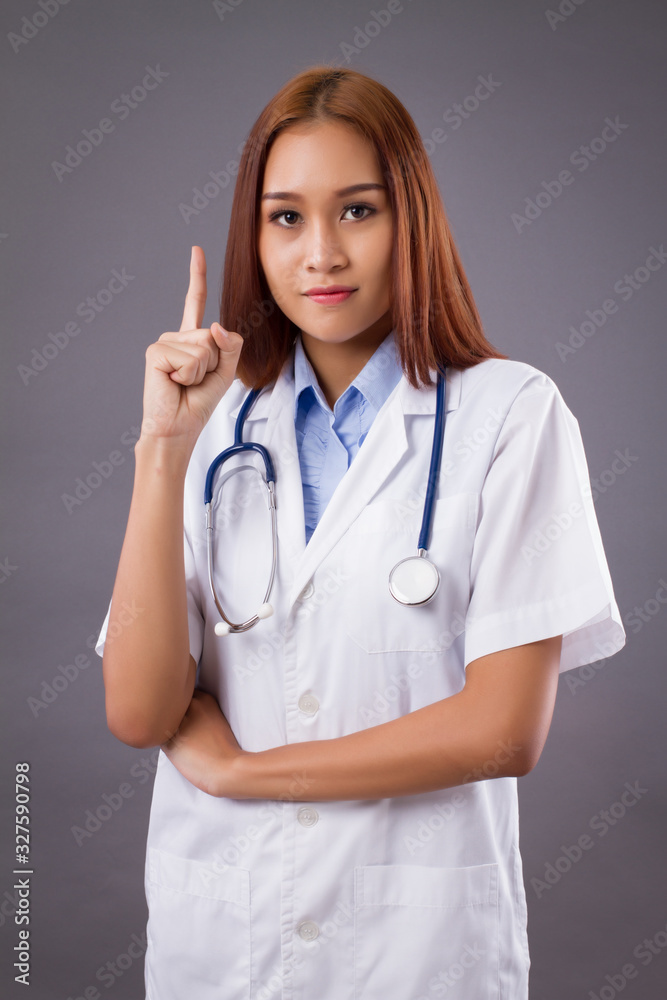 portrait of asian woman doctor isolated, confident and friendly female doctor pointing up one finger portrait of asian woman doctor isolated, confident and friendly female doctor pointing up one finger