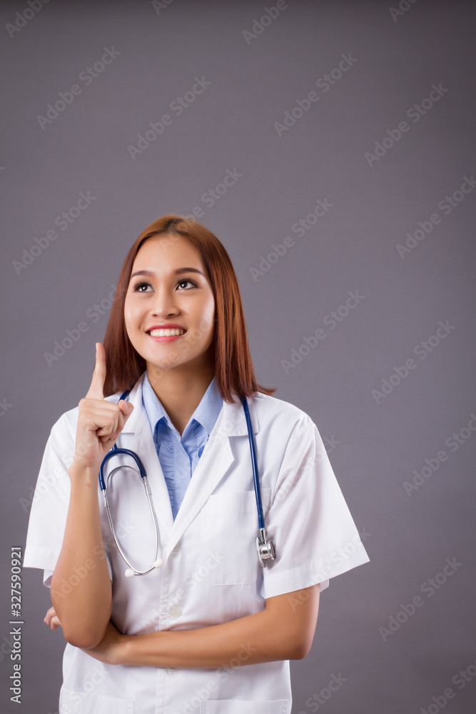 portrait of asian woman doctor isolated, confident and friendly female doctor pointing up one finger portrait of asian woman doctor isolated, confident and friendly female doctor pointing up one finger