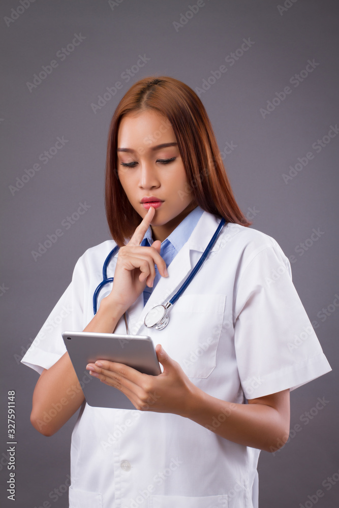 asian woman doctor thinking and using smart computer tablet in job; concept of medication with technology, AI in hospital, high technology doctor asian woman doctor thinking and using smart computer tablet in job; concept of medication with technology, AI in hospital, high technology doctor