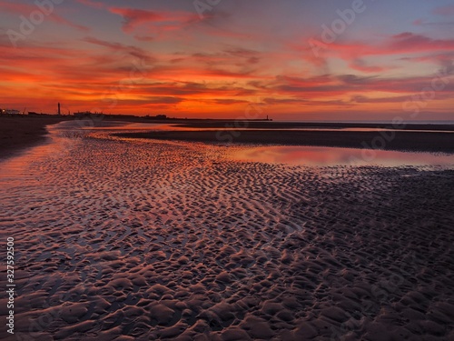 Beautiful sunset in the beach of Dunkerque north of France. Colorful Sunset sky and cloud.