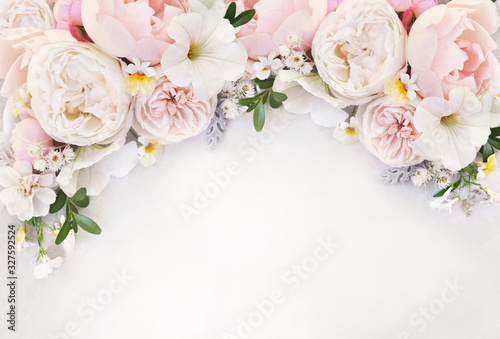 Delicate blossoming roses and blooming flowers festive background  pastel and soft bouquet floral card  selective focus  toned