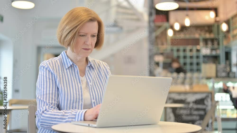 Laptop use by Creative Old Woman in Cafe Laptop use by Creative Old Woman in Cafe