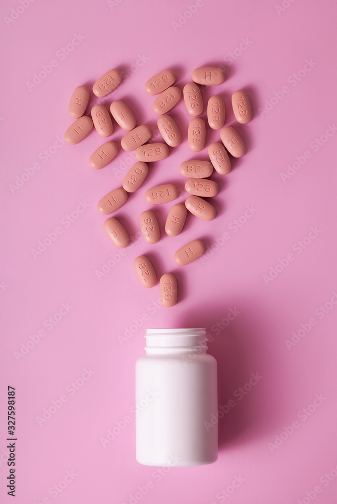 HIV/AIDS therapy pills on pink background. HIV/AIDS therapy pills on pink background.