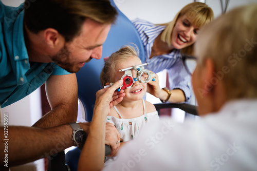 Ophthalmologist, optometrist checking child vision looking for problems and caring for eye © NDABCREATIVITY