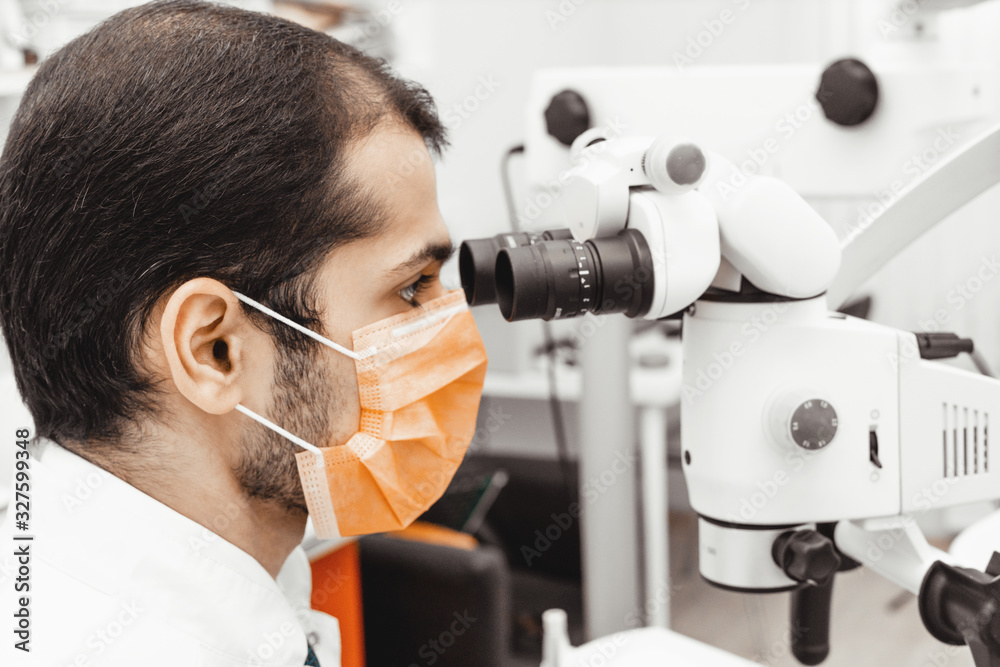 Young male dentist doctor at his workplace. Professional uniform and equipment of a dentist. Healthcare Equipping a doctor’s workplace. Dentistry Young male dentist doctor at his workplace. Professional uniform and equipment of a dentist. Healthcare Equipping a doctor’s workplace. Dentistry