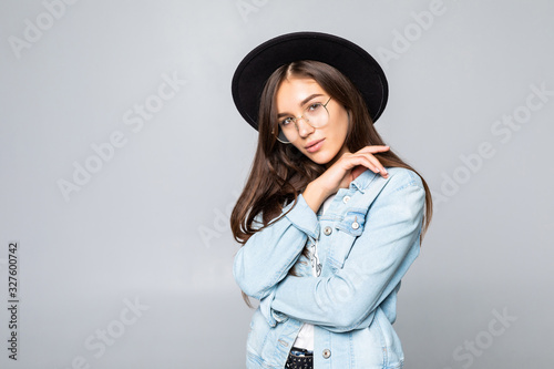 Portrait of young woman in black floppy hat isolated on white background