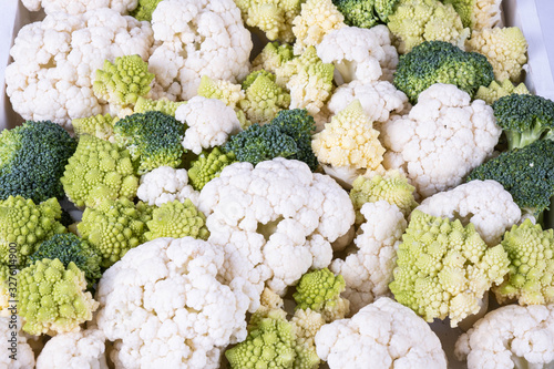 a lot of broccoli and cauliflower on a table