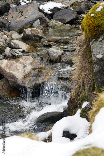 spring in the mountains with melt water in a creek