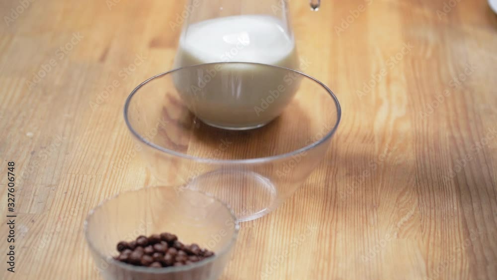 Somebody Puts The Jar Of Milk Next To The Bowl With Chocolate Cornflake Balls And The Empty Bowl. It is Going To Be Healthy Breakfast. Somebody Puts The Jar Of Milk Next To The Bowl With Chocolate Cornflake Balls And The Empty Bowl. It is Going To Be Healthy Breakfast.
