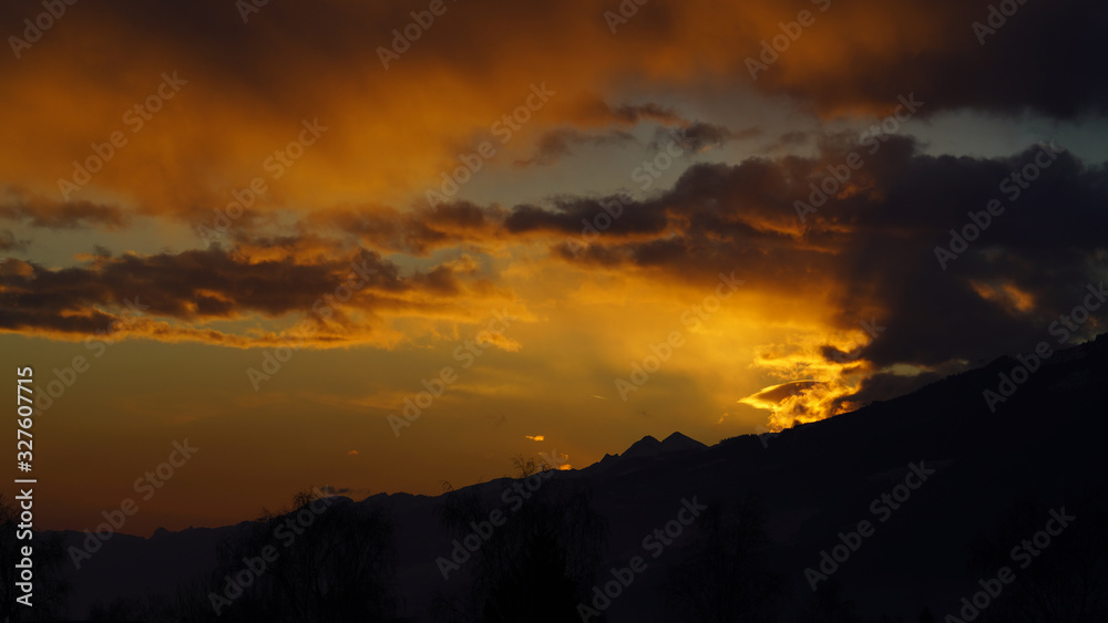 beautiful orange sky with clouds and mountain silhouette in the morning 