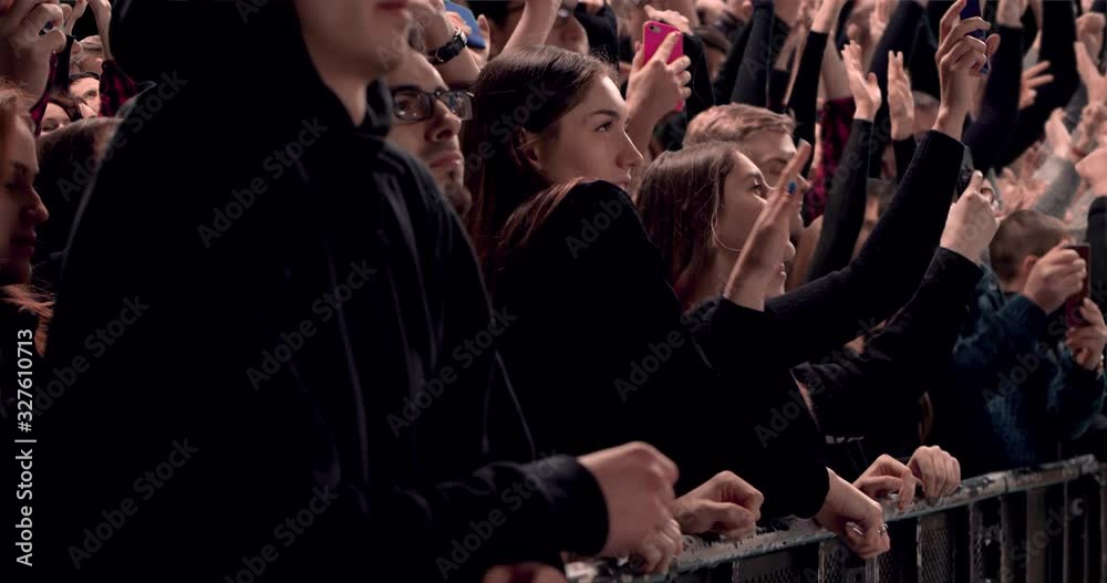 Model released, Side view of huge crowd jumping and cheering at a concert or a show. Shot on RED Helium 8K in RAW