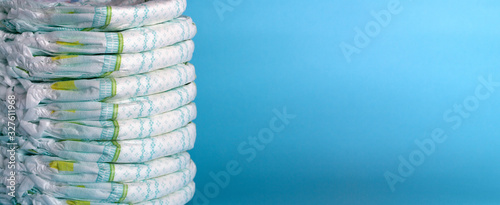 Stack of diapers. Banner. Blue background photo