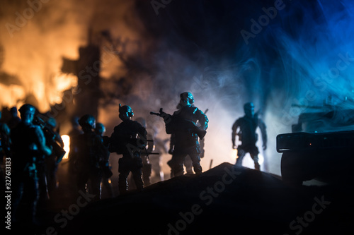 War Concept. Military silhouettes fighting scene on war fog sky background, World War Soldiers Silhouette Below Cloudy Skyline At night.