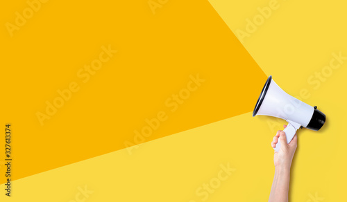 Person holding a megaphone with hard shadow photo