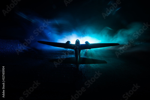 German Junker (Ju-88) night bomber at night. Artwork decoration with scale model of jet-propelled plane in possession. photo