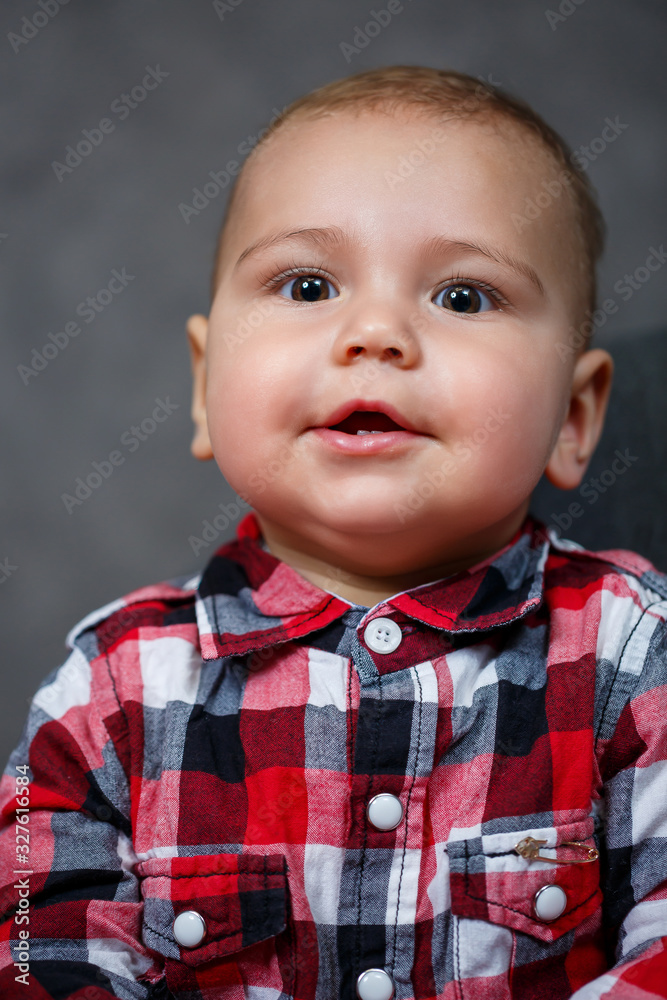 Little baby boy in shirt on grey background smile beautifully Little baby boy in shirt on grey background smile beautifully