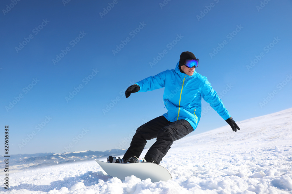 Man snowboarding on snowy hill. Winter vacation Man snowboarding on snowy hill. Winter vacation