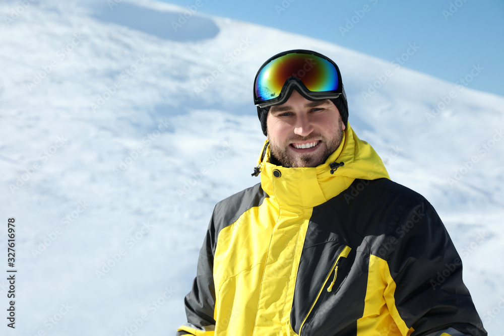 Happy young man in mountains. Winter vacation Happy young man in mountains. Winter vacation