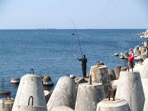 BALTIYSK, RUSSIA. Fishing on the Baltic Sea with tetrapods photo