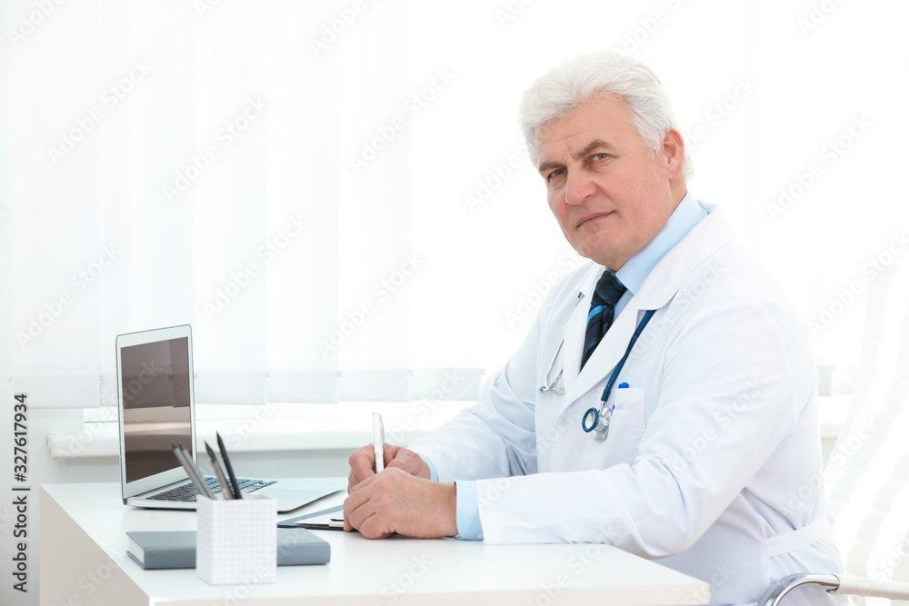 Portrait of senior doctor in white coat at workplace Portrait of senior doctor in white coat at workplace