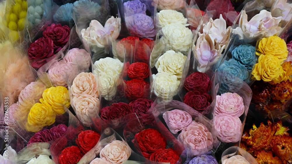 Colorful artificial roses for sale, wrapped in transparent wrapper.