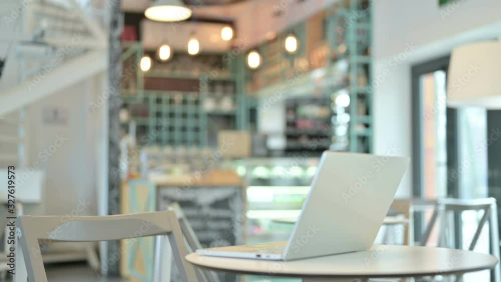 Young Woman Open Laptop on Top of Table in Cafe Young Woman Open Laptop on Top of Table in Cafe