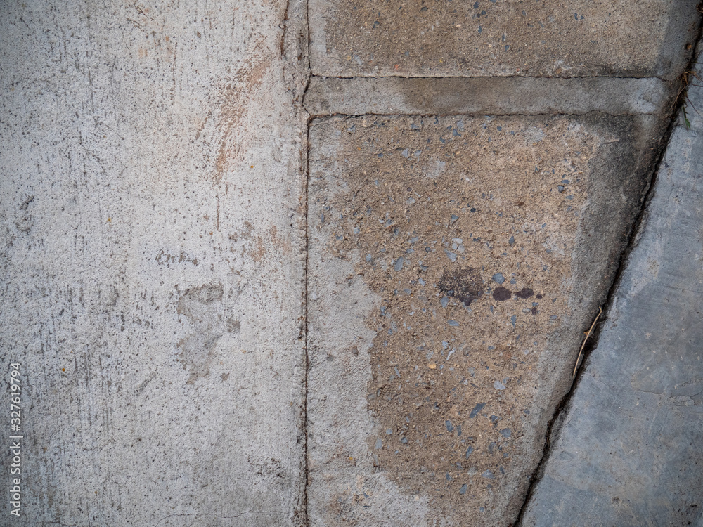 Concrete ground with a concrete tiles on a footpath Concrete ground with a concrete tiles on a footpath