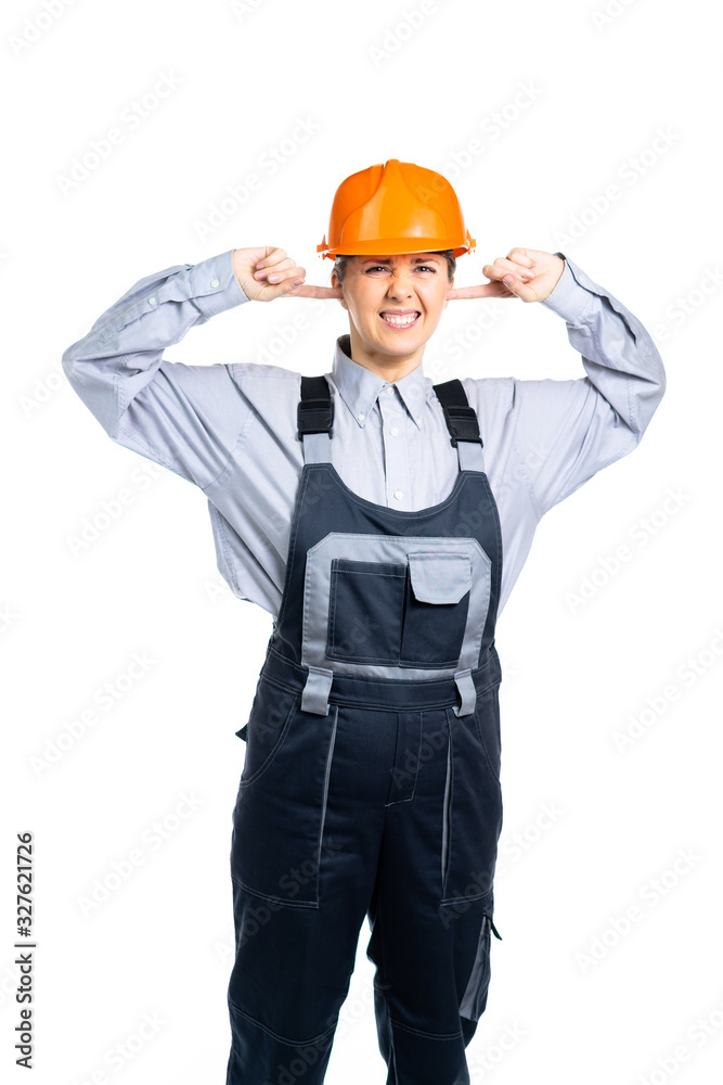 Female construction engineer does not want to hear anything. The construction site is working loudly. Isolated Female construction engineer does not want to hear anything. The construction site is working loudly. Isolated
