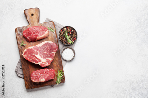 Variety of fresh raw beef steaks photo