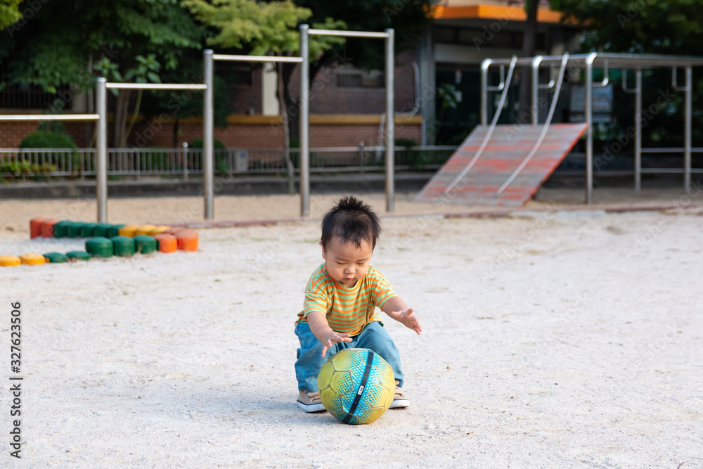 Asian cute baby play with soccer ball alone Asian cute baby play with soccer ball alone