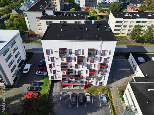 Aerial view of the brand new apartment building. White modern apartment building with red balconies. photo