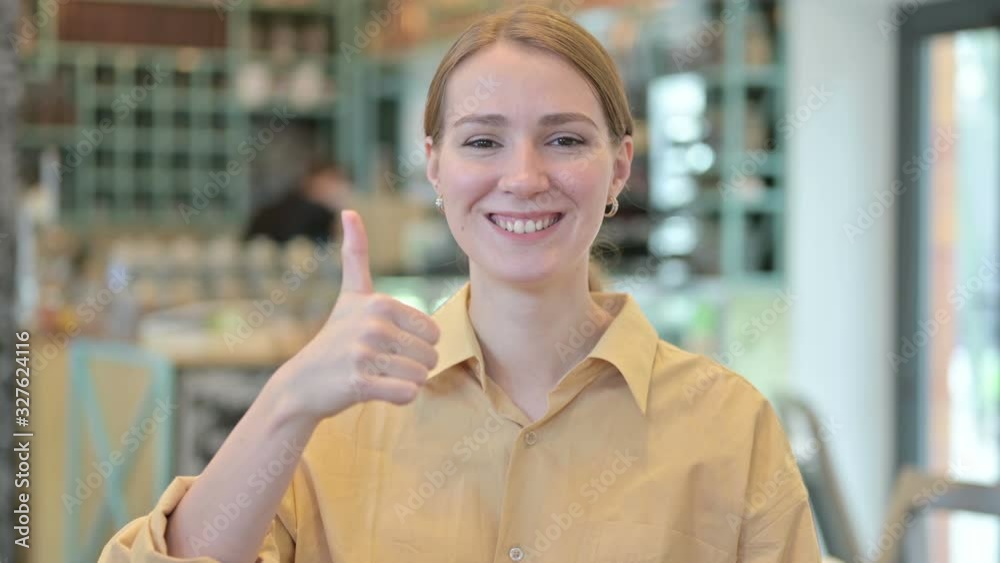 Portrait of Thumbs up by Positive Young Woman Portrait of Thumbs up by Positive Young Woman