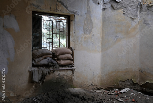 Sandbags piled up at a window of a house in the buffer zone "Green Line" in Nicosia, Cyprus